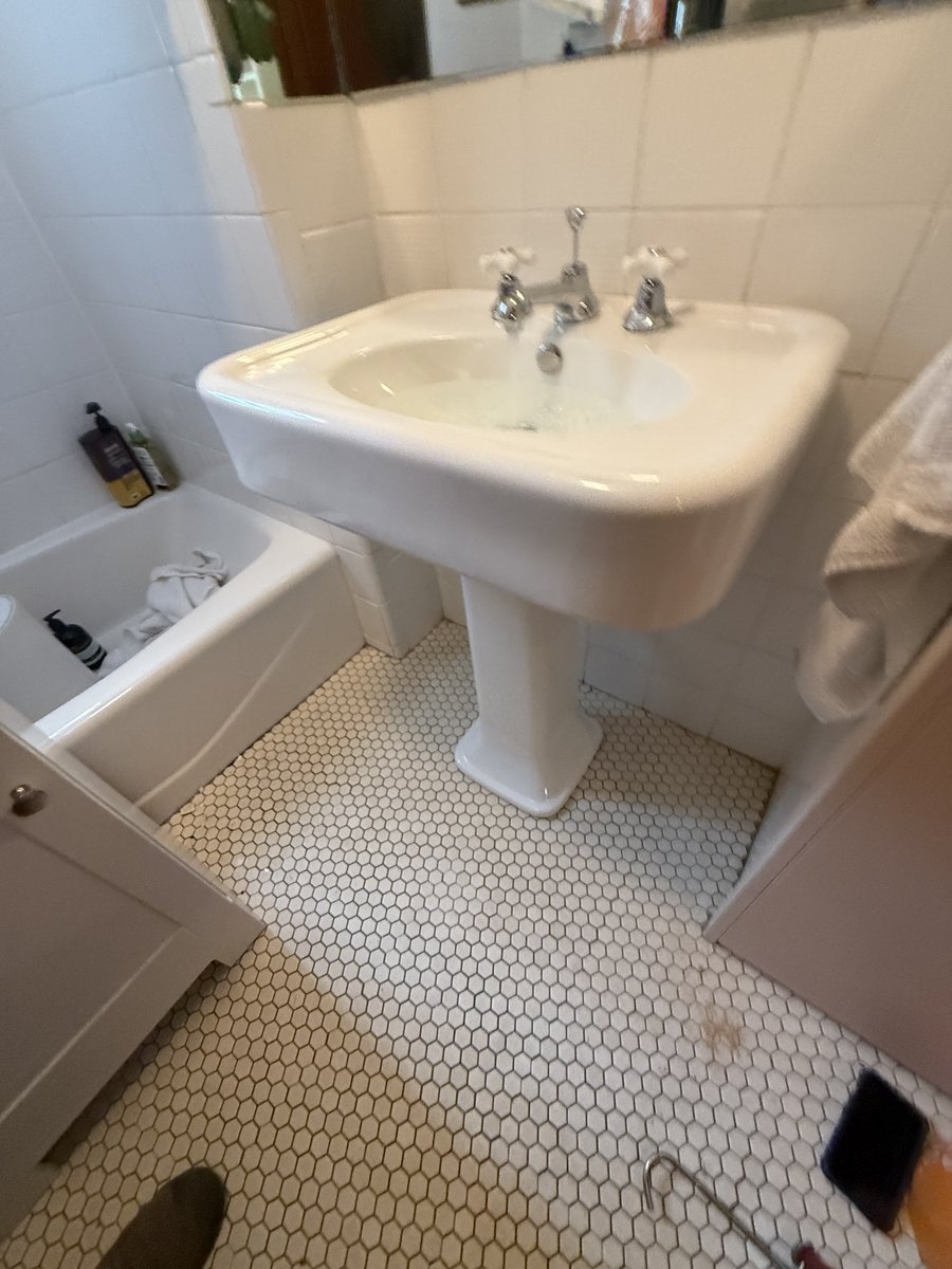 Installed bathroom pedestal sink and faucet