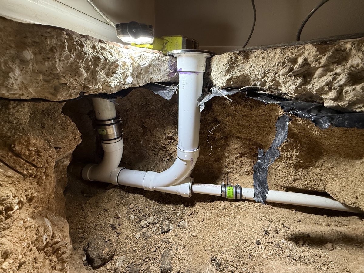 Pipe repair exposed beneath a concrete slab